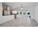 Modern kitchen with stainless steel appliances, granite countertops, and an adjacent dining area at 1720 Emerald Dr, Clearwater, FL 33756