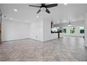 Open-concept living space featuring sleek tile floors and ample natural light at 1720 Emerald Dr, Clearwater, FL 33756