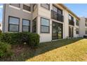 Exterior of condo featuring grass, windows, and a small balcony at 2017 Skimmer W Ct # 416, Clearwater, FL 33762