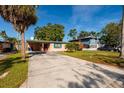 Tan single story home, long driveway and covered porch at 4126 Carson Ne St, St Petersburg, FL 33703