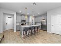 Spacious kitchen with a large island, stainless steel appliances, and wood-look tile flooring at 4236 Cloud Hopper Way, Lutz, FL 33559