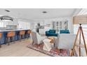 Open living area with a kitchen island, sofa, chairs, and modern decor at 4395 50Th S Ter, St Petersburg, FL 33711