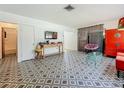 Open living room with unique flooring, a large window, and bright furniture accents at 5995 59Th N Way, St Petersburg, FL 33709