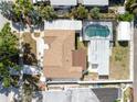 An aerial view showcases the home, screened pool, landscaping, and surrounding neighborhood at 7313 8Th N Ave, St Petersburg, FL 33710