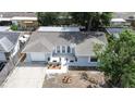 Aerial view of a neatly maintained home with an attached garage and landscaped front yard in a suburban neighborhood at 7830 Judith Cres, Port Richey, FL 34668