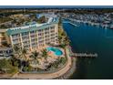 An aerial showcases Boca Ciega's resort-style living, including a pool, dock, and serene waterfront views at 8800 Bay Pines Blvd # 303, St Petersburg, FL 33709