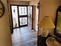Inviting foyer with decorative glass door and sidelights, tile floor, and warm lighting at 8810 41St N St, Pinellas Park, FL 33782