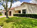 Beautifully maintained single-story home with lush green lawn, mature tree, and red tile roof at 8810 41St N St, Pinellas Park, FL 33782