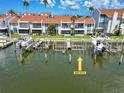 View of condo boat slips featuring boat lifts, docks, and canal access at 337 Rex Pl # E, Madeira Beach, FL 33708