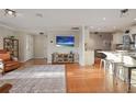 Cozy living room featuring wood floors, stylish furniture, and an open floor plan with a view into the kitchen at 10812 96Th St, Largo, FL 33773