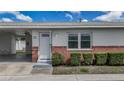Charming home featuring a white front door, adjacent carport, and well-maintained landscaping at 12400 Park Blvd # 121, Seminole, FL 33772
