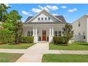Beautifully landscaped home with a bright red front door, inviting porch, and manicured lawn at 1511 47Th N Ave, St Petersburg, FL 33703