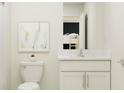Bathroom featuring modern vanity with quartz countertop and a view to bedroom at 15276 Rainbow Quartz St, Wimauma, FL 33598