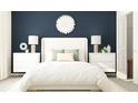 Bedroom showcases white furniture, a plush bed, dark blue wall, and stylish decor at 15276 Rainbow Quartz St, Wimauma, FL 33598