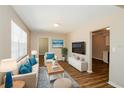 Bright living room with hardwood floors, stylish furniture, and a large window at 1602 E New Orleans Ave, Tampa, FL 33610