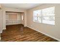 Inviting living room featuring built-in shelving, natural light, and hardwood floors at 1602 E New Orleans Ave, Tampa, FL 33610