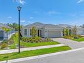 Charming single-story home with a well-manicured lawn and a brick driveway leading to a two-car garage at 17920 Nadine Pl, Nokomis, FL 34275