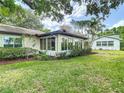 Beautiful backyard featuring a screen enclosed porch, lush lawn, and attractive landscaping at 2011 Halidom Way # 0, Sun City Center, FL 33573