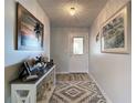 Bright entryway featuring a light gray color scheme, framed art, and a decorative console table at 2011 Halidom Way # 0, Sun City Center, FL 33573