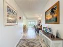 Bright hallway with wood-look floors, decorated with framed art and a decorative console table at 2011 Halidom Way # 0, Sun City Center, FL 33573