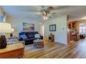 Cozy living room featuring modern flooring, a ceiling fan, and an open layout at 2131 Cedar Dr, Dunedin, FL 34698