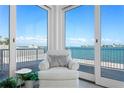 Cozy sitting area with large glass doors offering stunning water views at 2171 E Vina Del Mar Blvd, St Pete Beach, FL 33706