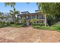 Stately two-story home featuring a circular driveway and manicured landscaping at 2320 Coffee Pot Ne Blvd, St Petersburg, FL 33704
