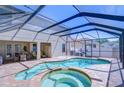 A refreshing pool with spa and screened enclosure, surrounded by a brick patio at 2515 Cross More St, Valrico, FL 33594