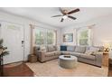 Bright living room with large windows, a sectional sofa, and hardwood floors at 2751 36Th N Ave, St Petersburg, FL 33713