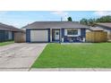 Charming home with a well-manicured lawn, welcoming front porch, and an attached single car garage at 3106 Whispering S Dr, Largo, FL 33771