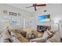 Comfortable living room features a large sectional sofa and a modern wall-mounted television at 3106 Whispering S Dr, Largo, FL 33771