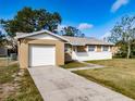 Charming single-story home featuring a one-car garage and a well-maintained driveway at 428 Flamingo Dr, Apollo Beach, FL 33572