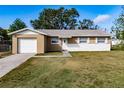 Charming single-story home featuring a one-car garage and a well-maintained front yard at 428 Flamingo Dr, Apollo Beach, FL 33572