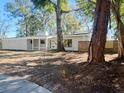 Attractive single-story home featuring a minimalist design surrounded by mature trees at 4310 7Th S St, St Petersburg, FL 33705