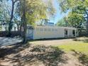 Side view of a home with a well-manicured lawn and horizontal architectural accents at 4310 7Th S St, St Petersburg, FL 33705