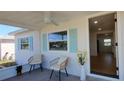 Inviting screened-in porch with seating and views of the neighborhood through light blue shutters at 4550 53Rd N Ave, St Petersburg, FL 33714