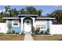 Charming blue home with white trim, beautiful plants, and a welcoming front entrance at 4601 N 38Th St, Tampa, FL 33610