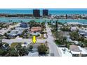 A high angle view of the property showing the street and surroundings including the bay in the distance at 512 79Th Ave, St Pete Beach, FL 33706