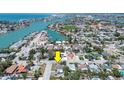 Aerial view showcasing the property's proximity to the water, nearby buildings, and the surrounding neighborhood at 512 79Th Ave, St Pete Beach, FL 33706
