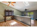 Bright living room featuring hardwood floors, skylights, and modern ceiling fans at 6462 92Nd N Pl # 804, Pinellas Park, FL 33782