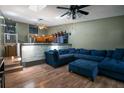Spacious living room with a large blue sectional, open to the kitchen at 6462 92Nd N Pl # 804, Pinellas Park, FL 33782