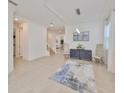 Bright living room with neutral decor, tile floors, and stylish furniture arrangement at 933 Signet Dr, Apollo Beach, FL 33572