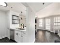 Open-concept living room with modern kitchen, fireplace, and lots of natural light at 1000 W Horatio St # 207, Tampa, FL 33606
