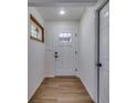 Bright entryway featuring wood floors and a decorative stained-glass window, leading into the home at 11480 Genter Dr, Spring Hill, FL 34609