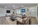 Contemporary living room with stylish furniture, modern decor, and abundant natural light from large windows at 11480 Genter Dr, Spring Hill, FL 34609