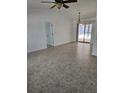 Open living space with tile flooring, leading to a screened patio and pool at 12619 98Th St, Largo, FL 33773