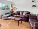Comfortable seating arrangement with wood laminate floors and natural light at 1325 58Th N St # 204A, St Petersburg, FL 33710