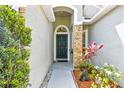Inviting front entryway featuring decorative stone and attractive landscaping at 21840 Waverly Shores Ln, Land O Lakes, FL 34637
