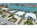 Captivating waterfront property with lush landscaping, circular driveway, and convenient access to the bay at 25 Dolphin Dr, Treasure Island, FL 33706