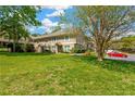 Townhome exterior view showcasing well-maintained landscaping and ample green space in a bright setting at 2897 Thaxton Dr # 62, Palm Harbor, FL 34684